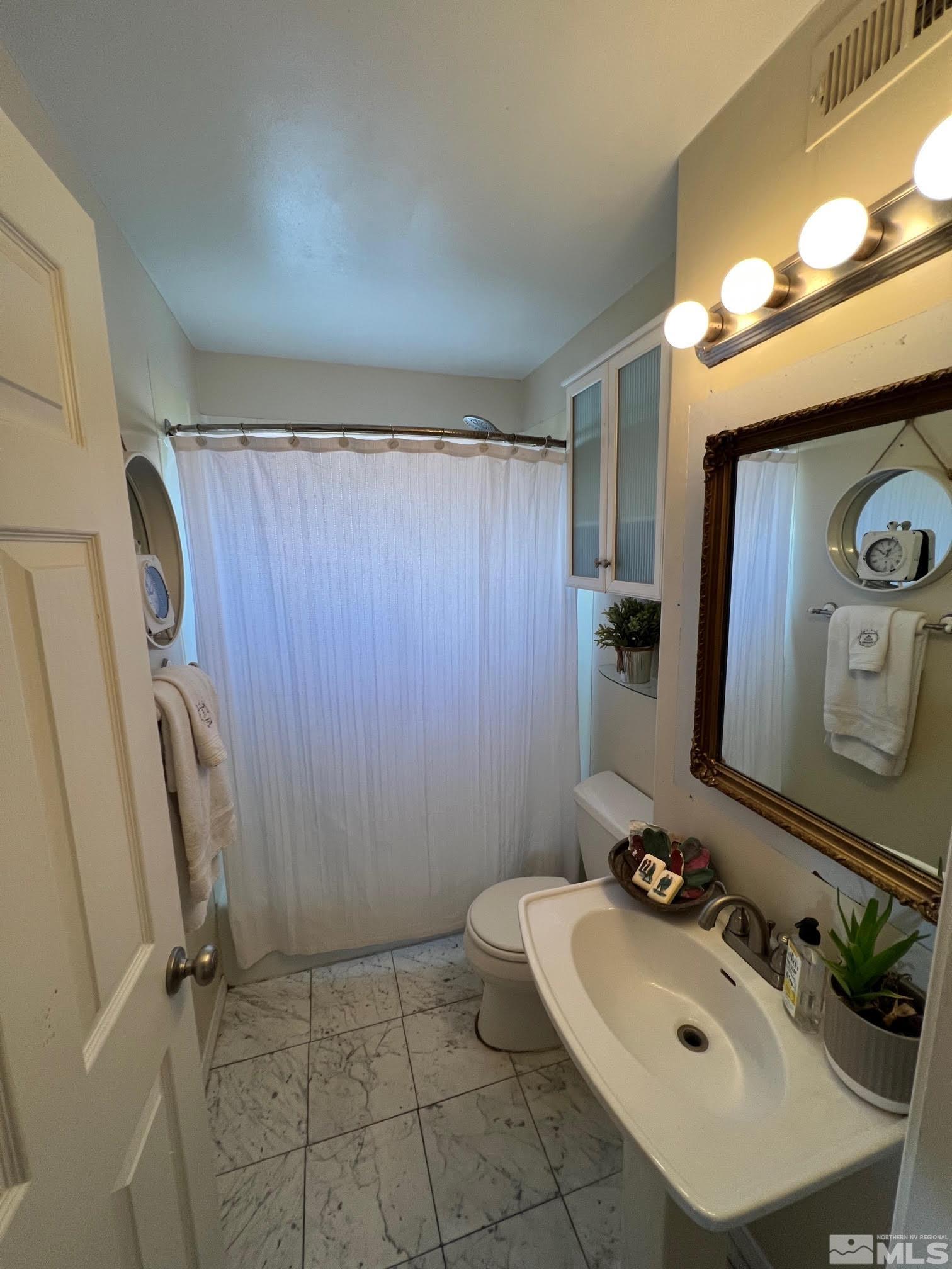2140 Arcane Avenue Reno, NV 89503 - Photo 11 of 15 a bathroom with a sink toilet and shower