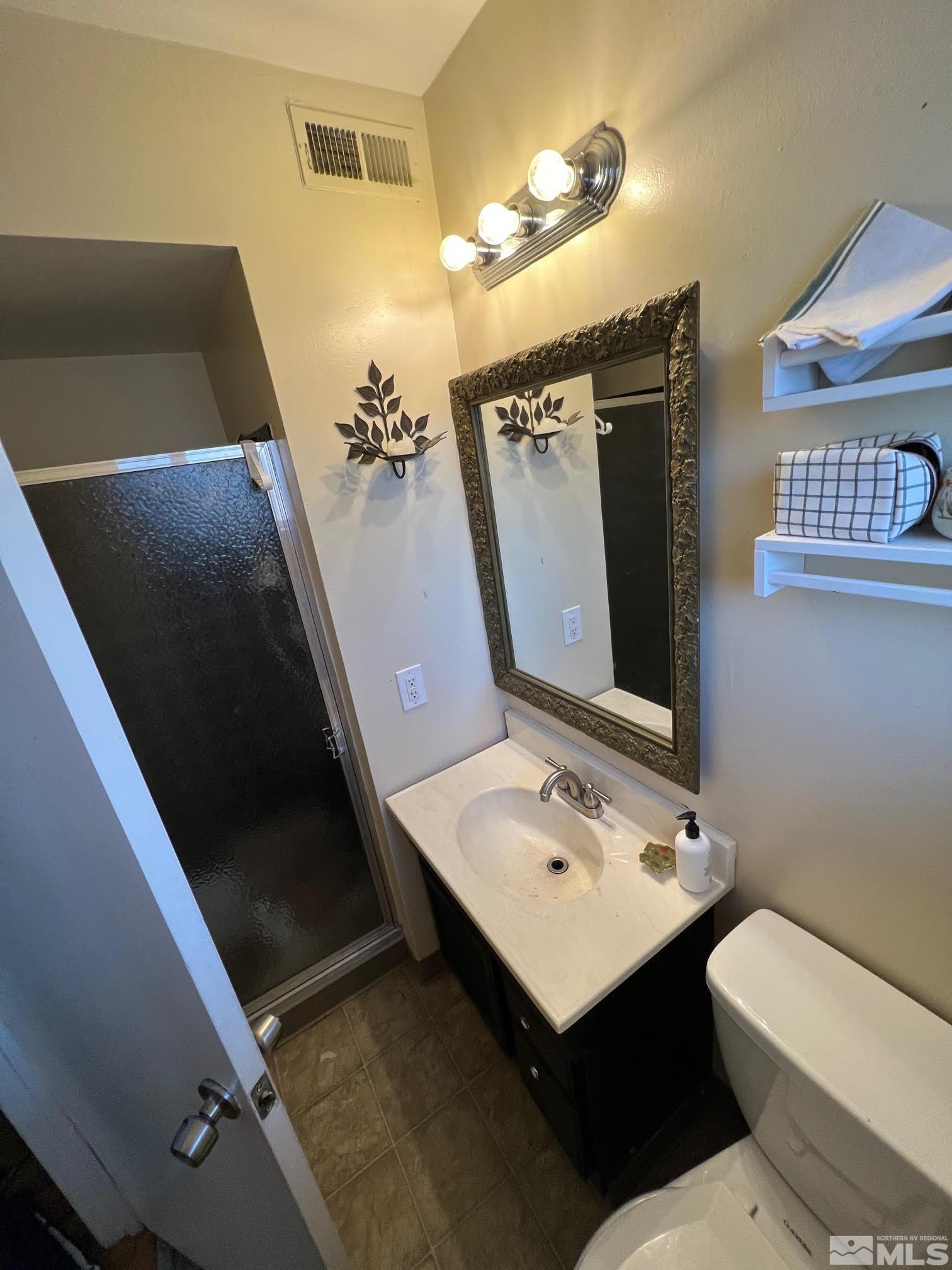 2140 Arcane Avenue Reno, NV 89503 - Photo 12 of 15 a bathroom with a sink toilet and mirror