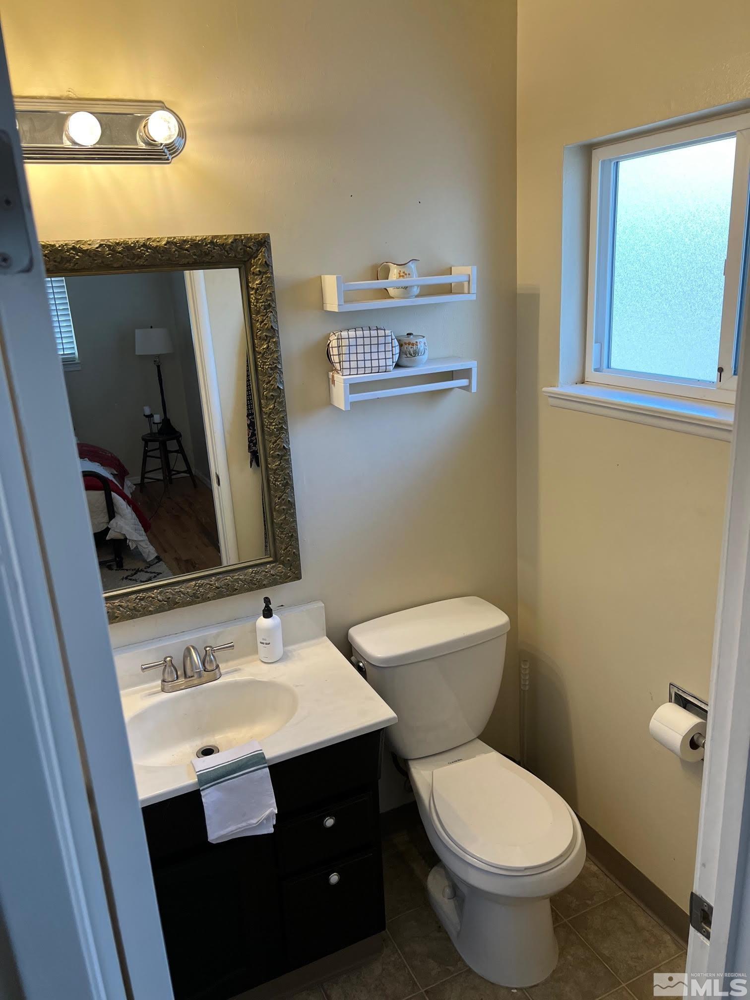 2140 Arcane Avenue Reno, NV 89503 - Photo 14 of 15 a bathroom with a toilet sink and mirror