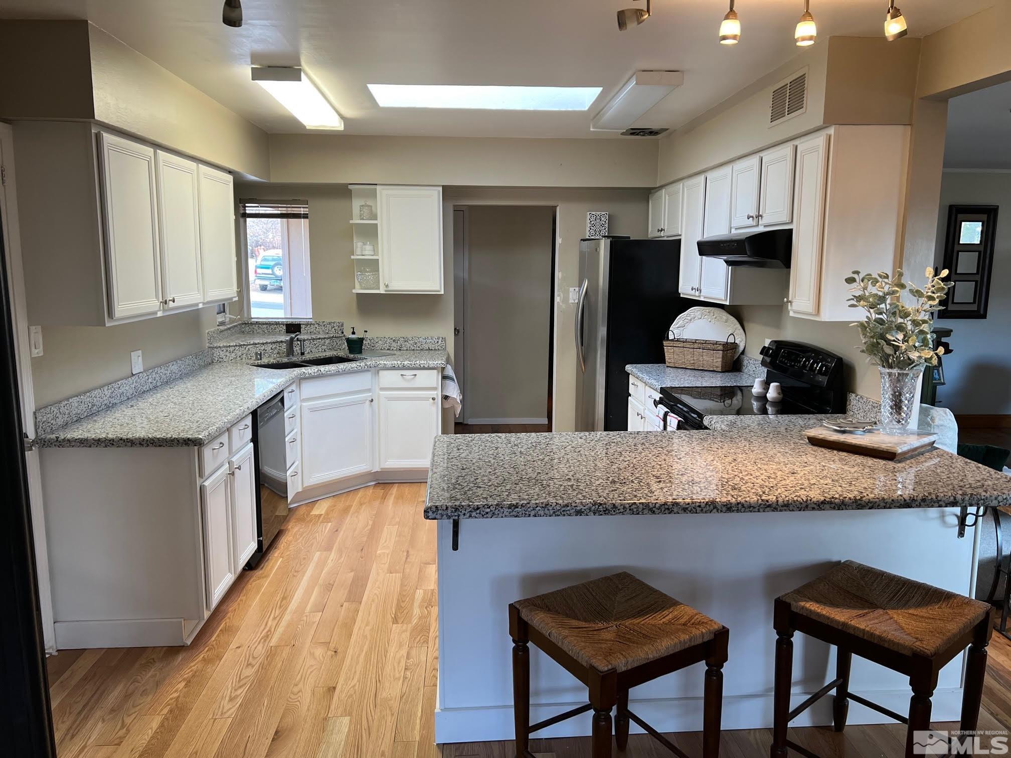 2140 Arcane Avenue Reno, NV 89503 - Photo 2 of 15 a kitchen with stainless steel appliances granite countertop wooden cabinets a stove a sink and a granite counter tops