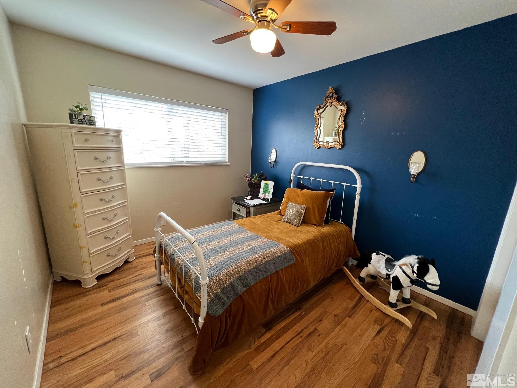 2140 Arcane Avenue Reno, NV 89503 - Photo 9 of 15 a bedroom with a bed and a chandelier
