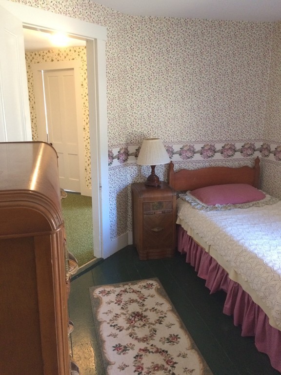 100 Leshure Road Rowe, MA 01367 - Photo 25 of 30 a bedroom with a bed and wooden floor
