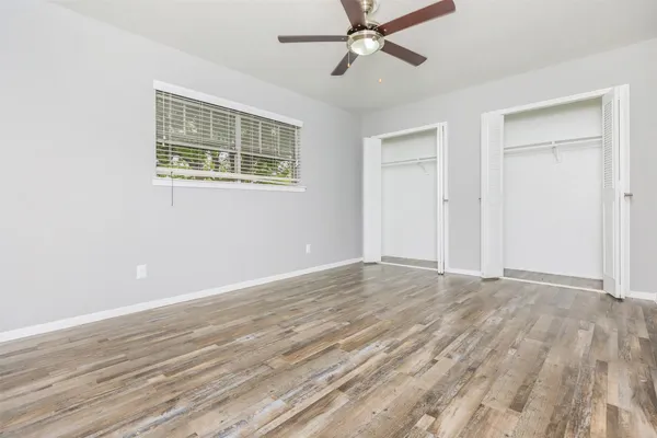a view of wooden floor and closet in a room