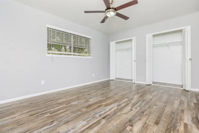 a view of wooden floor and closet in a room