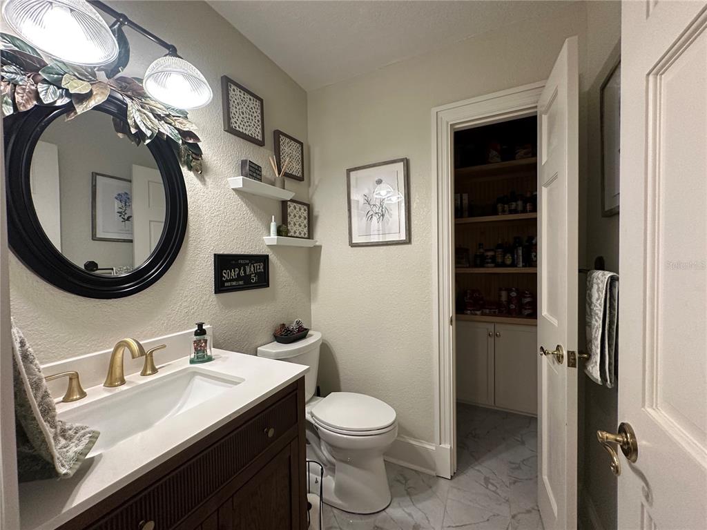 708 East Main Street Wauchula, FL 33873 - Photo 24 of 82 a bathroom with a toilet a sink and mirror