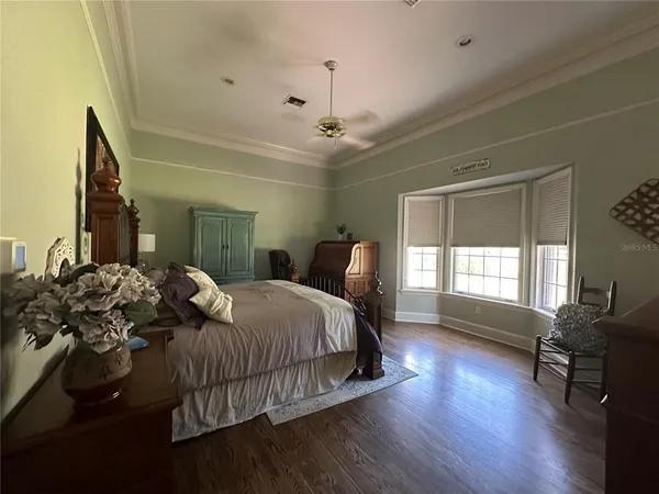 a bedroom with furniture and a wooden floor