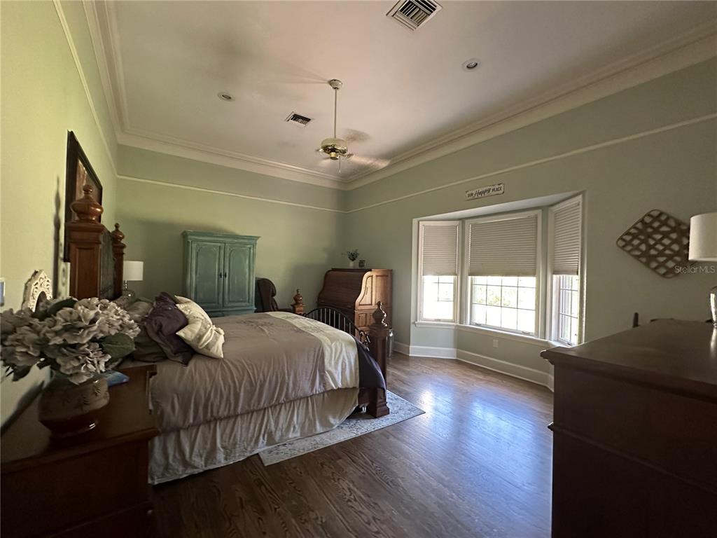 708 East Main Street Wauchula, FL 33873 - Photo 27 of 82 a bedroom with a bed and wooden floor