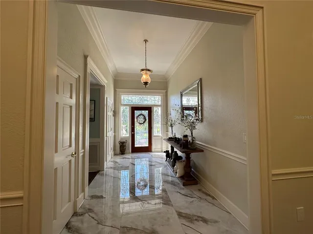 a view of a livingroom with furniture and a hallway