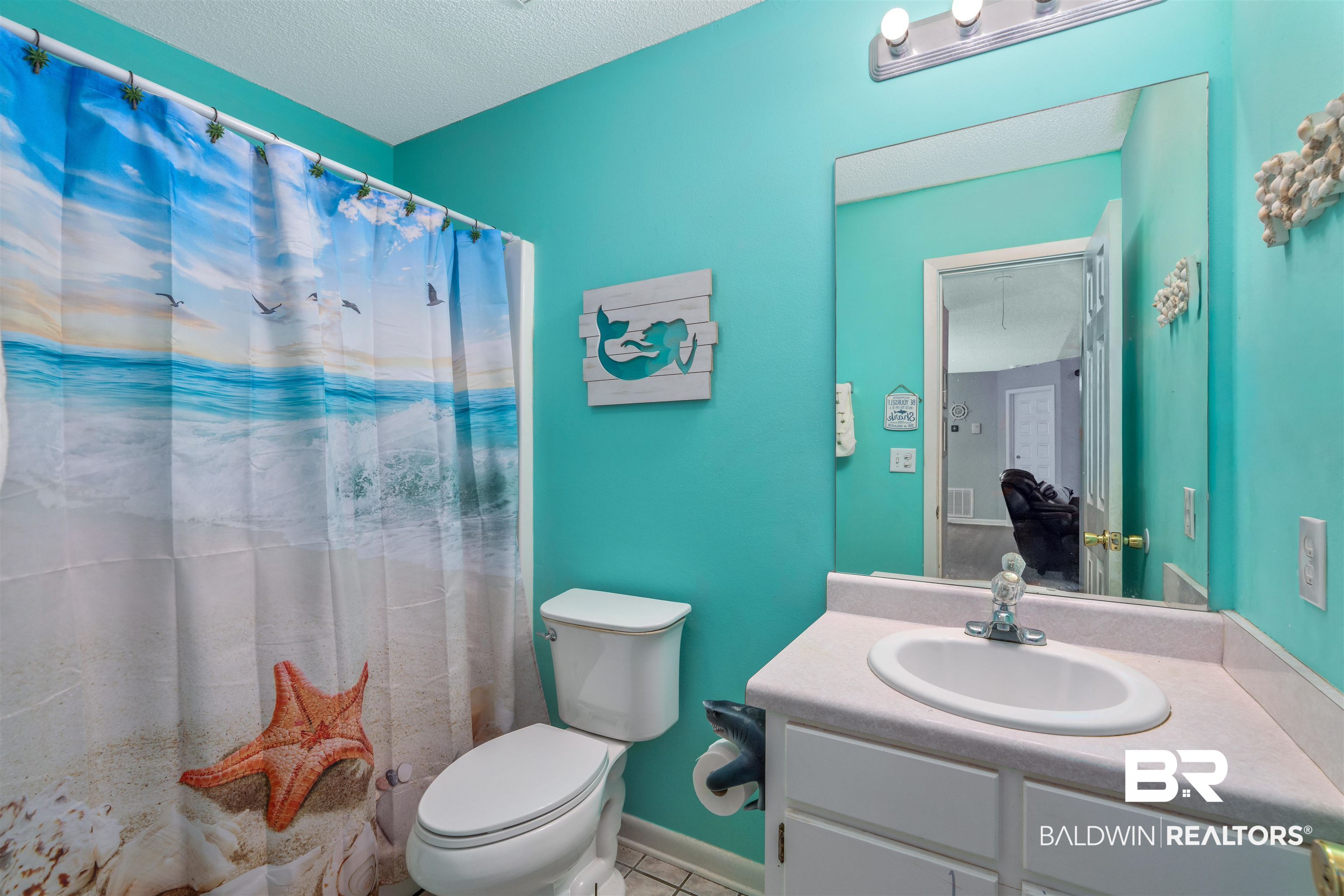 23186 Pecan Street Robertsdale, AL 36567 - Photo 15 of 36 Full bath featuring a shower with curtain, vanity, a textured ceiling, and tile patterned floors