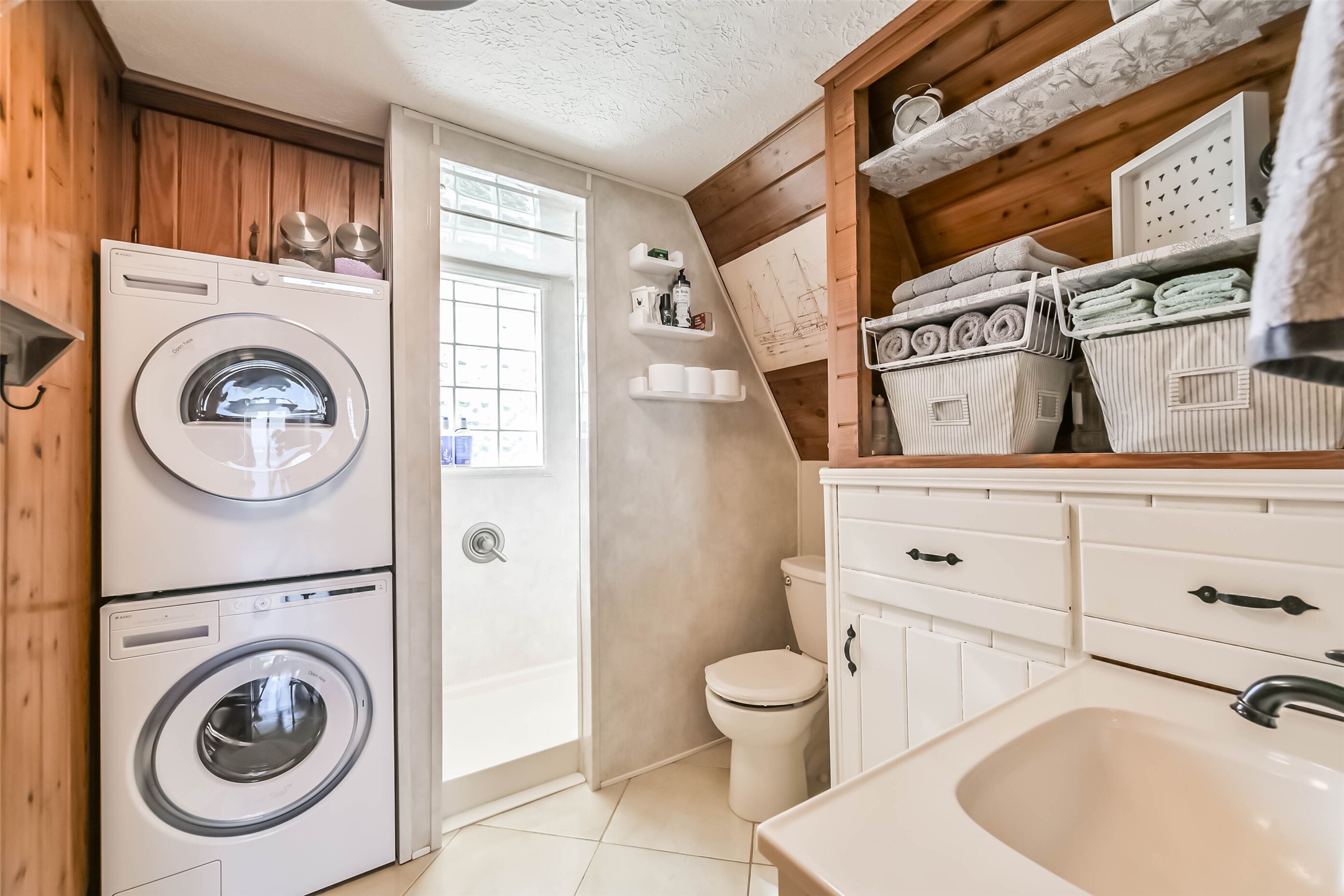 2009 Todville Road Seabrook, TX 77586 - Photo 11 of 46 a bathroom with a sink a washer and dryer