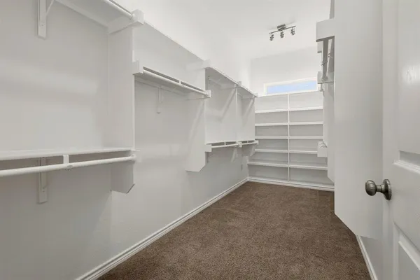 an empty room with a window and a bathroom