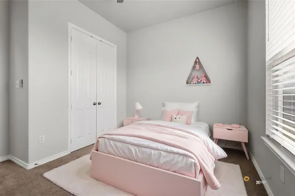 a bedroom with a bed and a potted plant