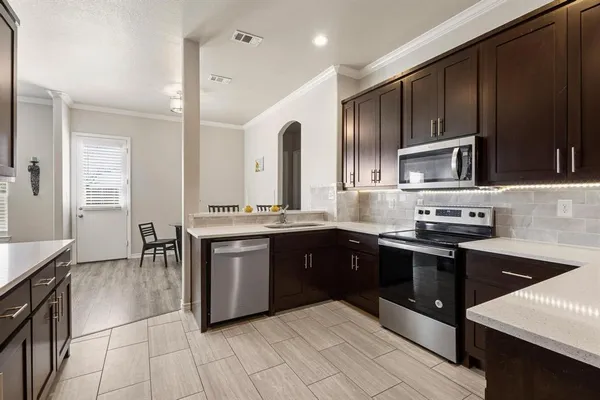 a kitchen with a sink stove and microwave