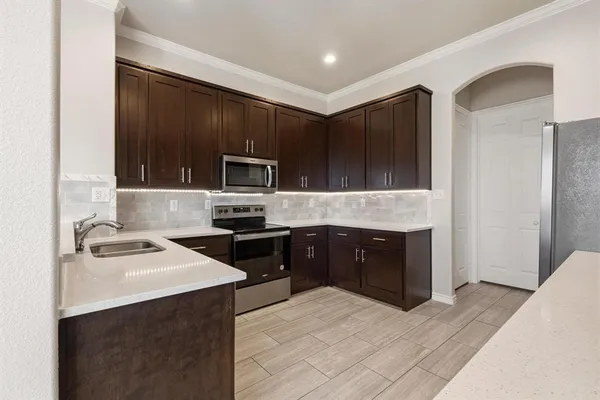 a kitchen with a refrigerator and a sink