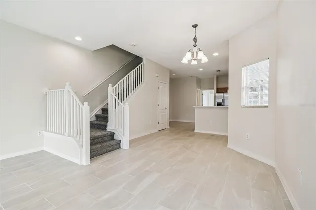 a view of a livingroom with wooden floor and stairs