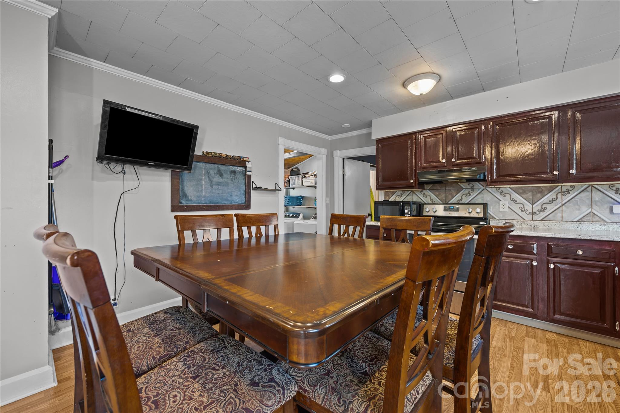 145 Duke Street Cooleemee, NC 27014 - Photo 13 of 27 a kitchen with stainless steel appliances granite countertop a stove a dining table and chairs