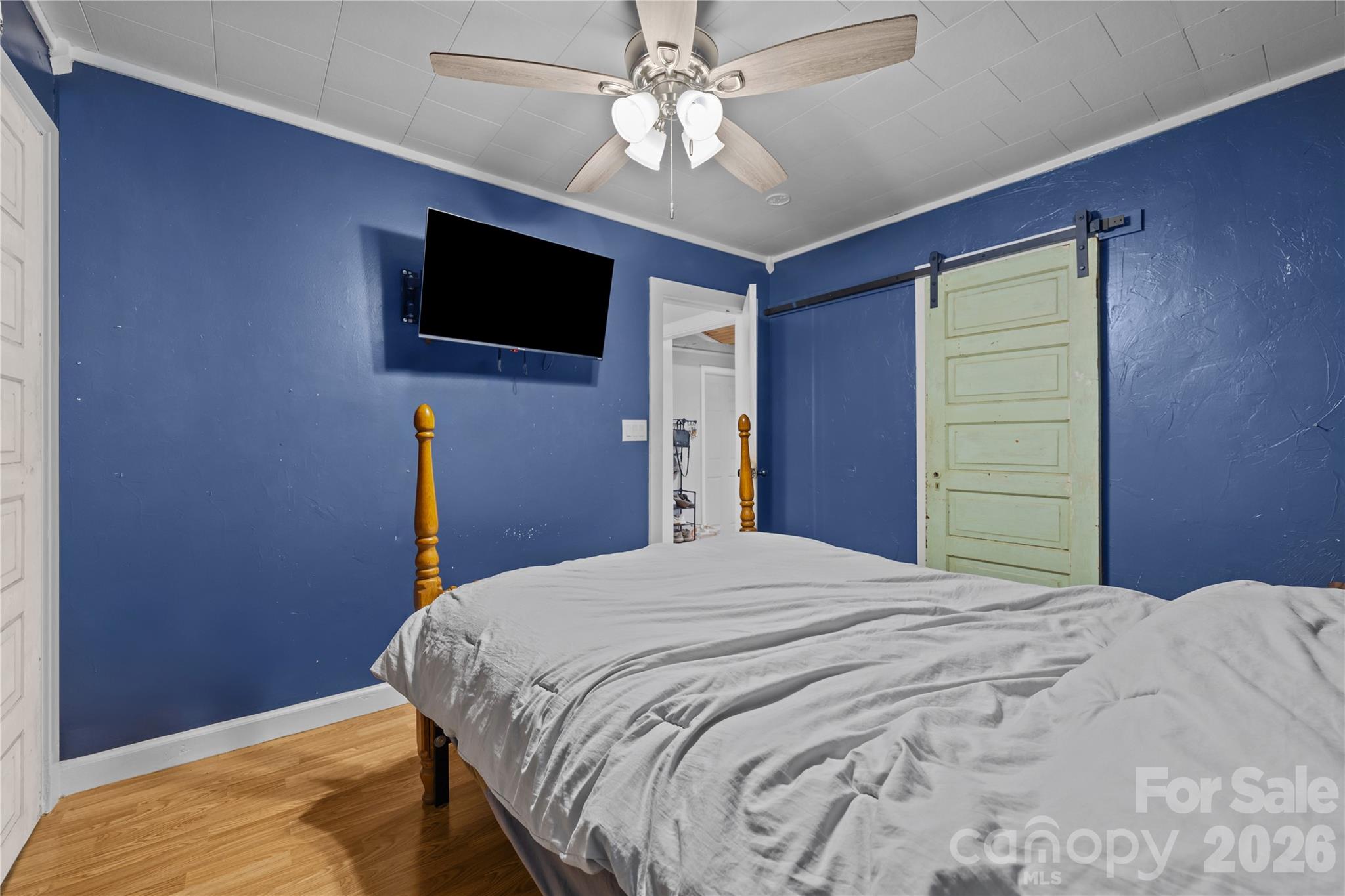 145 Duke Street Cooleemee, NC 27014 - Photo 20 of 27 a bedroom with a bed and a flat screen tv
