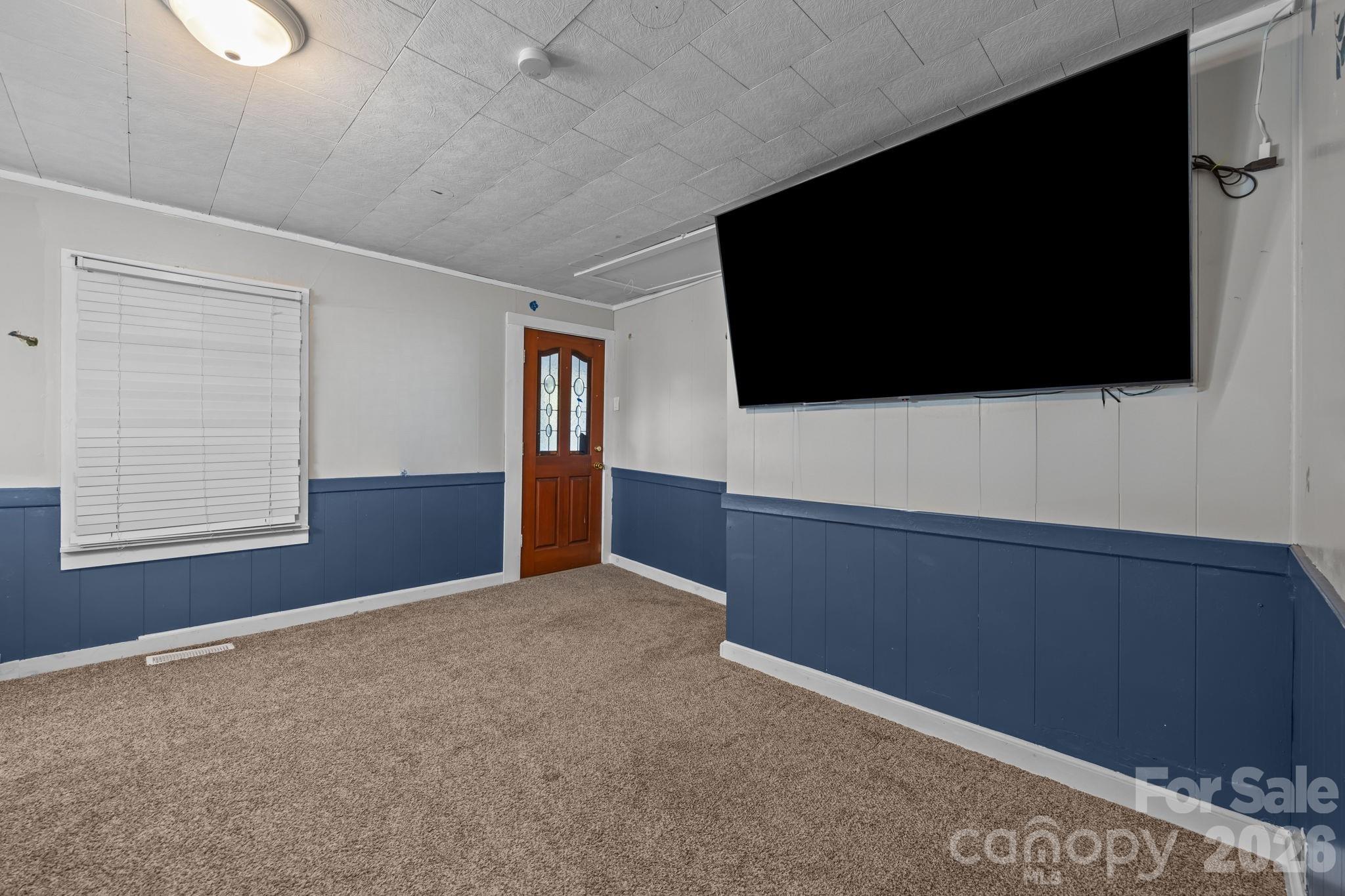 145 Duke Street Cooleemee, NC 27014 - Photo 6 of 27 a living room with a flat screen tv and a fireplace