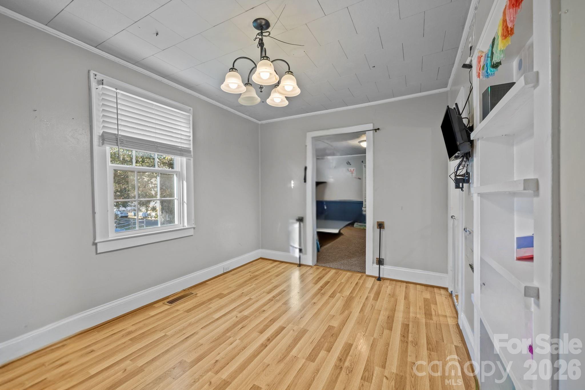 145 Duke Street Cooleemee, NC 27014 - Photo 8 of 27 a view of an empty room with wooden floor and a window