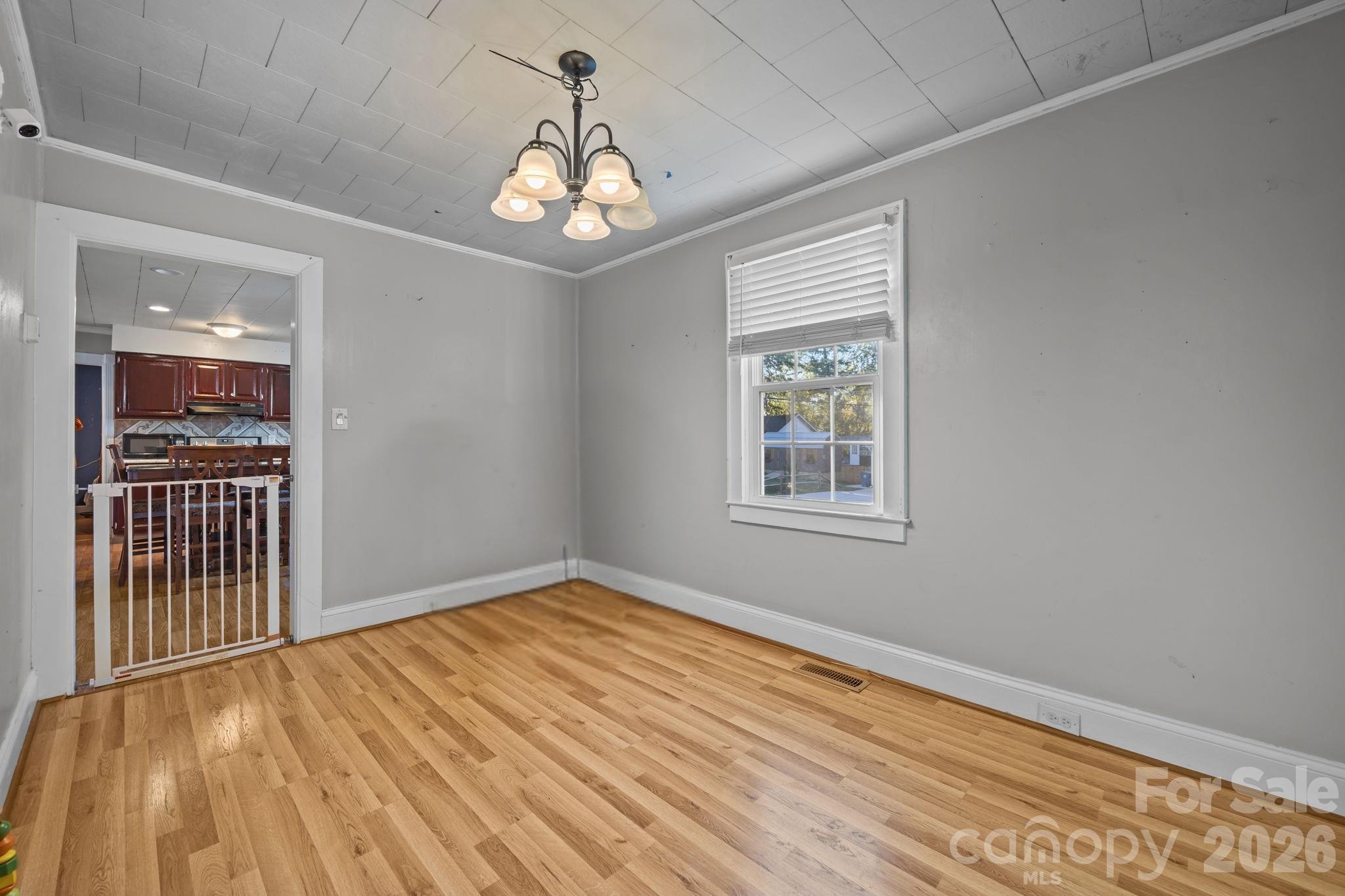 145 Duke Street Cooleemee, NC 27014 - Photo 9 of 27 a view of an empty room with wooden floor and a window