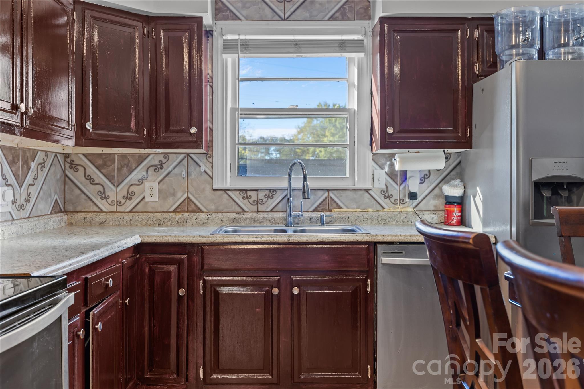 145 Duke Street Cooleemee, NC 27014 - Photo 10 of 27 a kitchen with a sink a refrigerator and cabinets