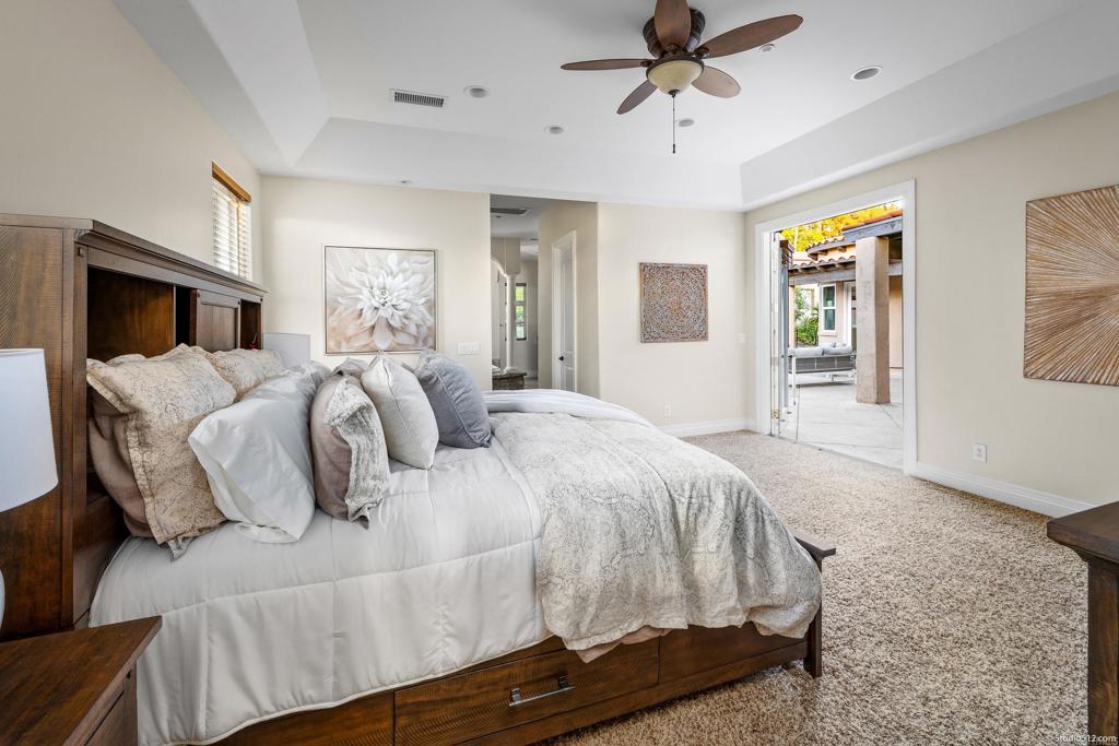 1455 Independence Way Vista, CA 92084 - Photo 17 of 31 a bedroom with a large bed and a chandelier