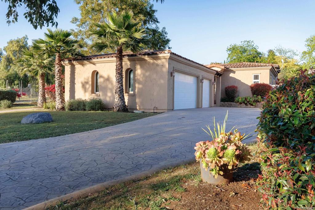 1455 Independence Way Vista, CA 92084 - Photo 24 of 31 a front view of a house with a yard and a garden