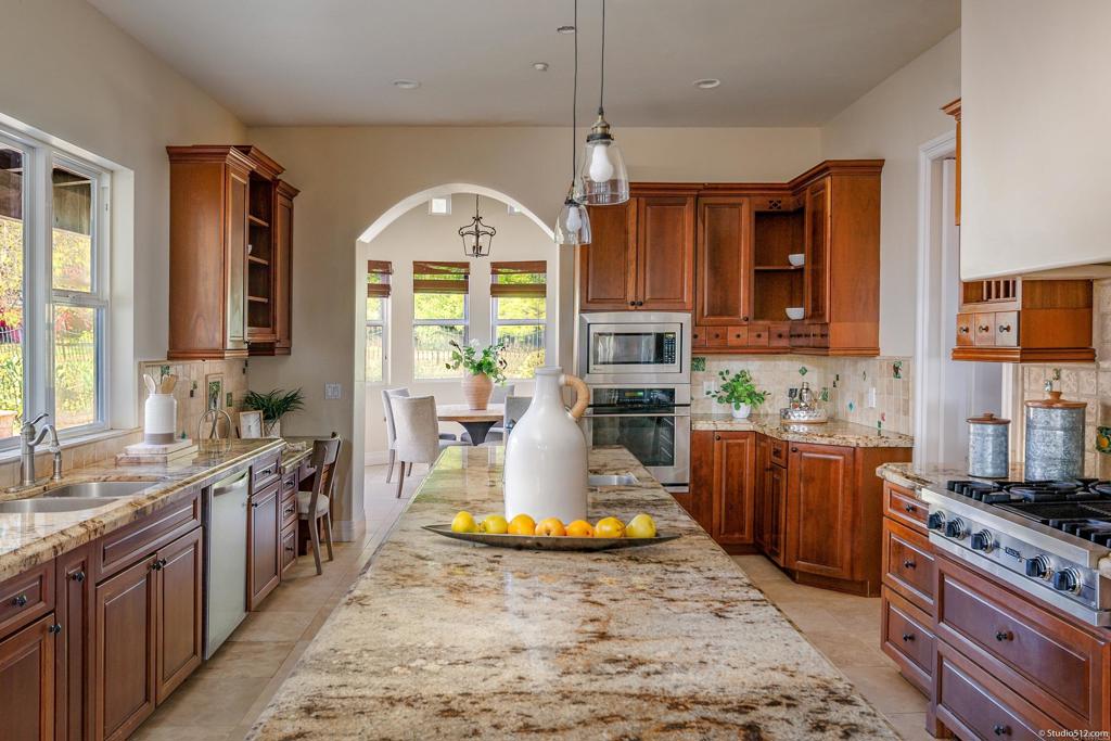 1455 Independence Way Vista, CA 92084 - Photo 8 of 31 a kitchen with sink a stove and cabinets