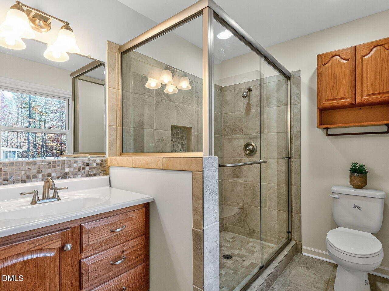 1019 Prologue Road Durham, NC 27712 - Photo 13 of 31 a bathroom with a shower sink vanity mirror and toilet