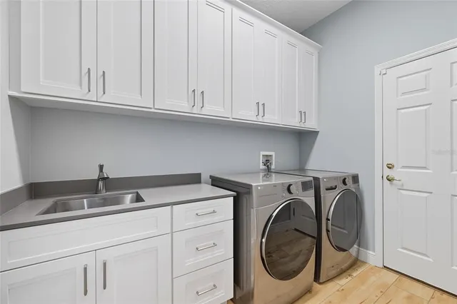 a living room with furniture a couch and dresser with wooden floor