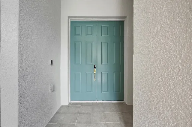 a kitchen with stainless steel appliances granite countertop a sink a stove a refrigerator and island with wooden floor