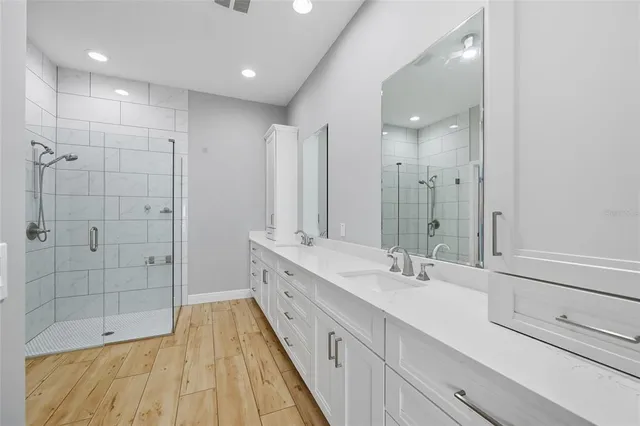 a view of a big room with wooden floor and windows