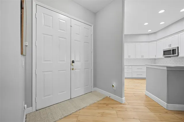 a kitchen with stainless steel appliances granite countertop a sink and a refrigerator