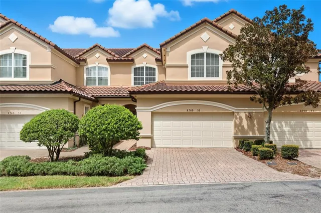 an aerial view of a house with garden space and lake view