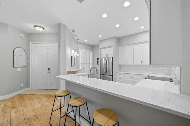 a kitchen with stainless steel appliances granite countertop a sink stove and microwave