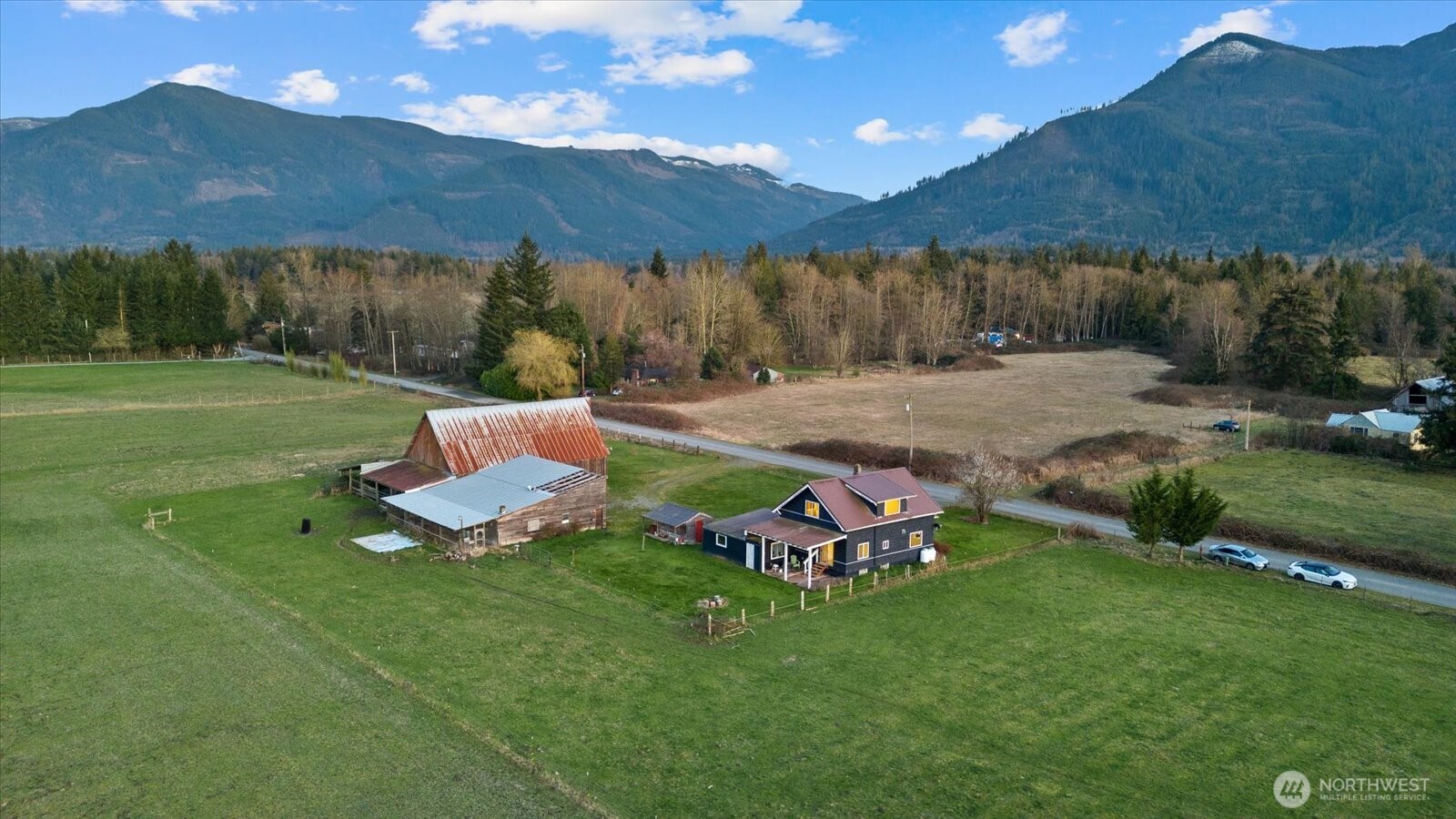 30731 Walberg Road Sedro-Woolley, WA 98284 - Photo 40 of 40 a view of a backyard with lawn chairs under an umbrella