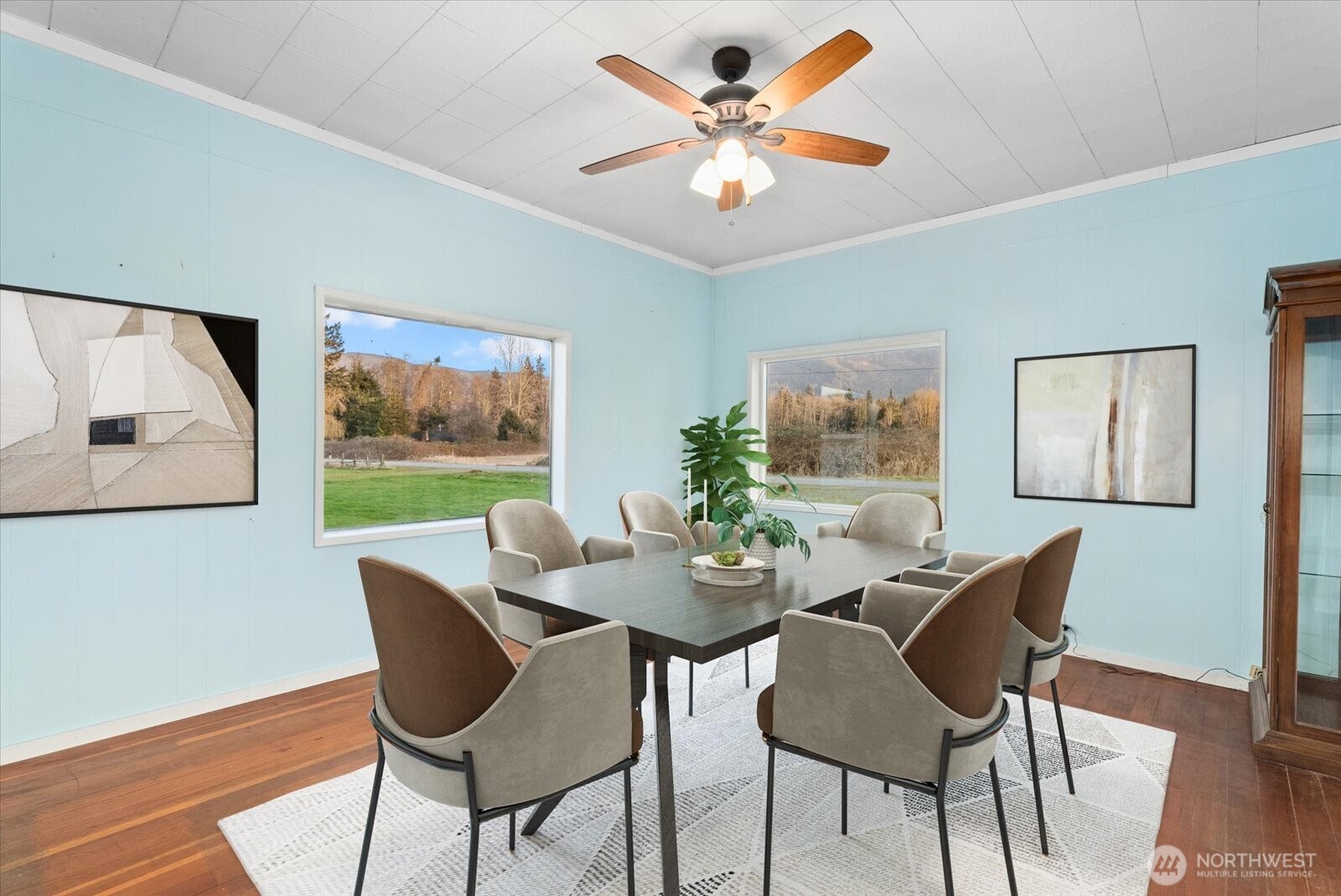 30731 Walberg Road Sedro-Woolley, WA 98284 - Photo 7 of 40 a view of a dining room with furniture a large window and wooden floor