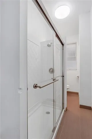 a bathroom with a shower and a glass door
