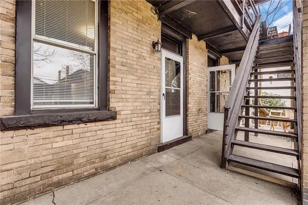 a view of front door of house with stairs