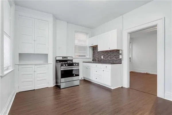 a kitchen with stainless steel appliances white cabinets and a sink