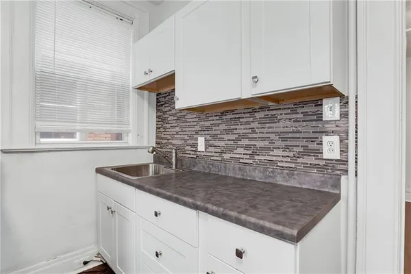 a kitchen with granite countertop a sink and a window