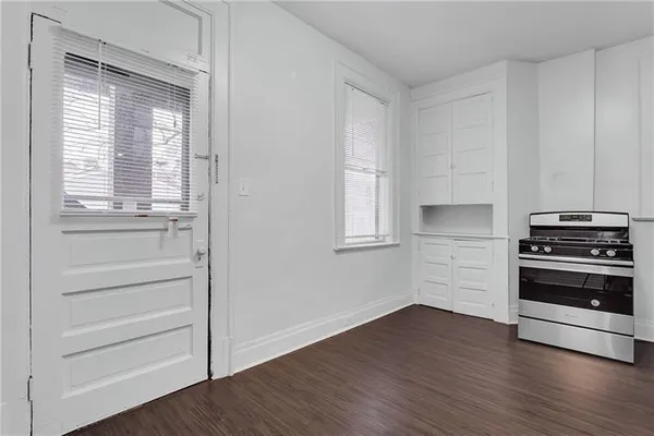 a kitchen with a wooden floor and a stove