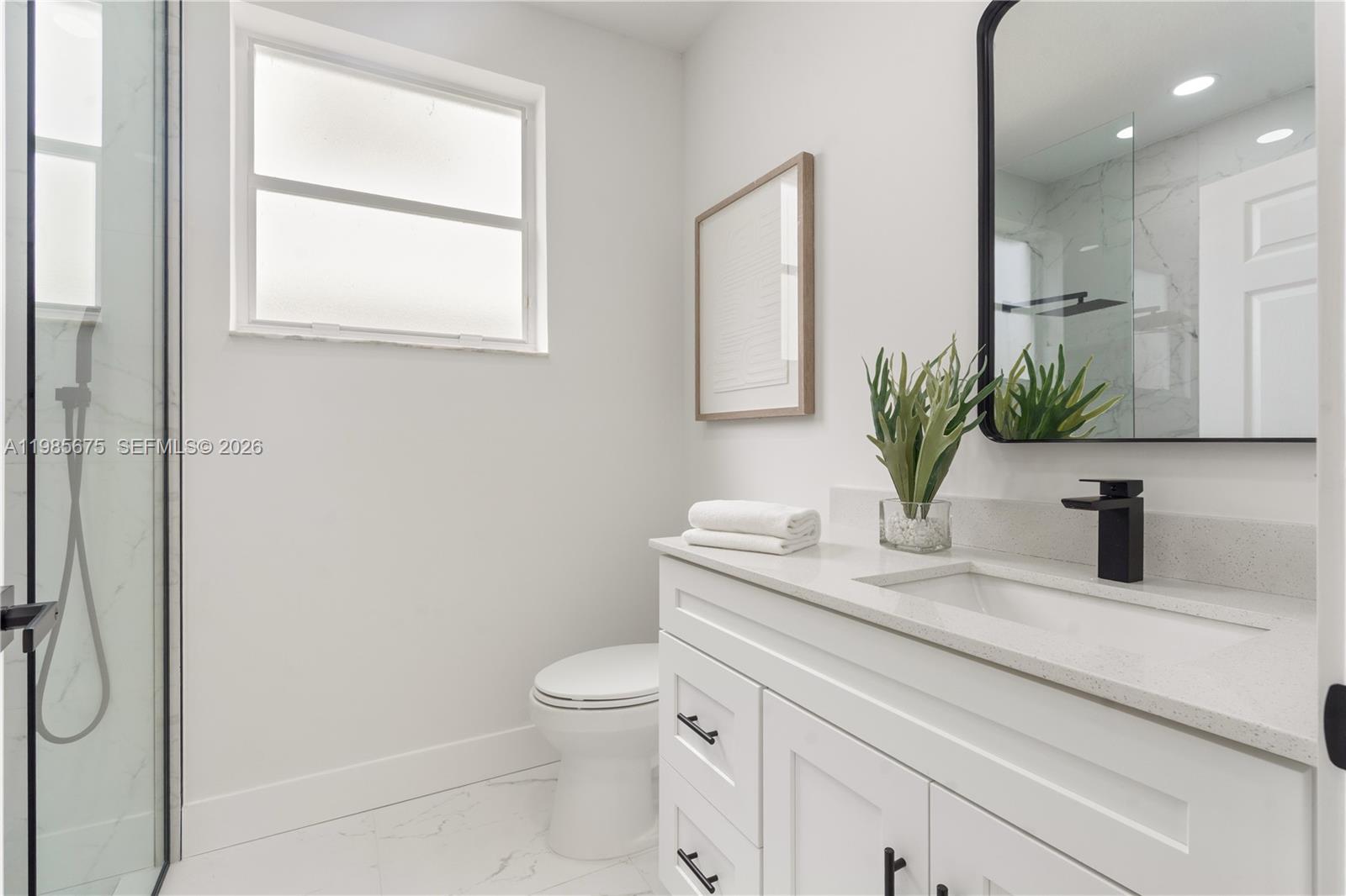 9840 Stover Way Wellington, FL 33414 - Photo 16 of 23 a bathroom with a granite countertop sink vanity mirror and toilet