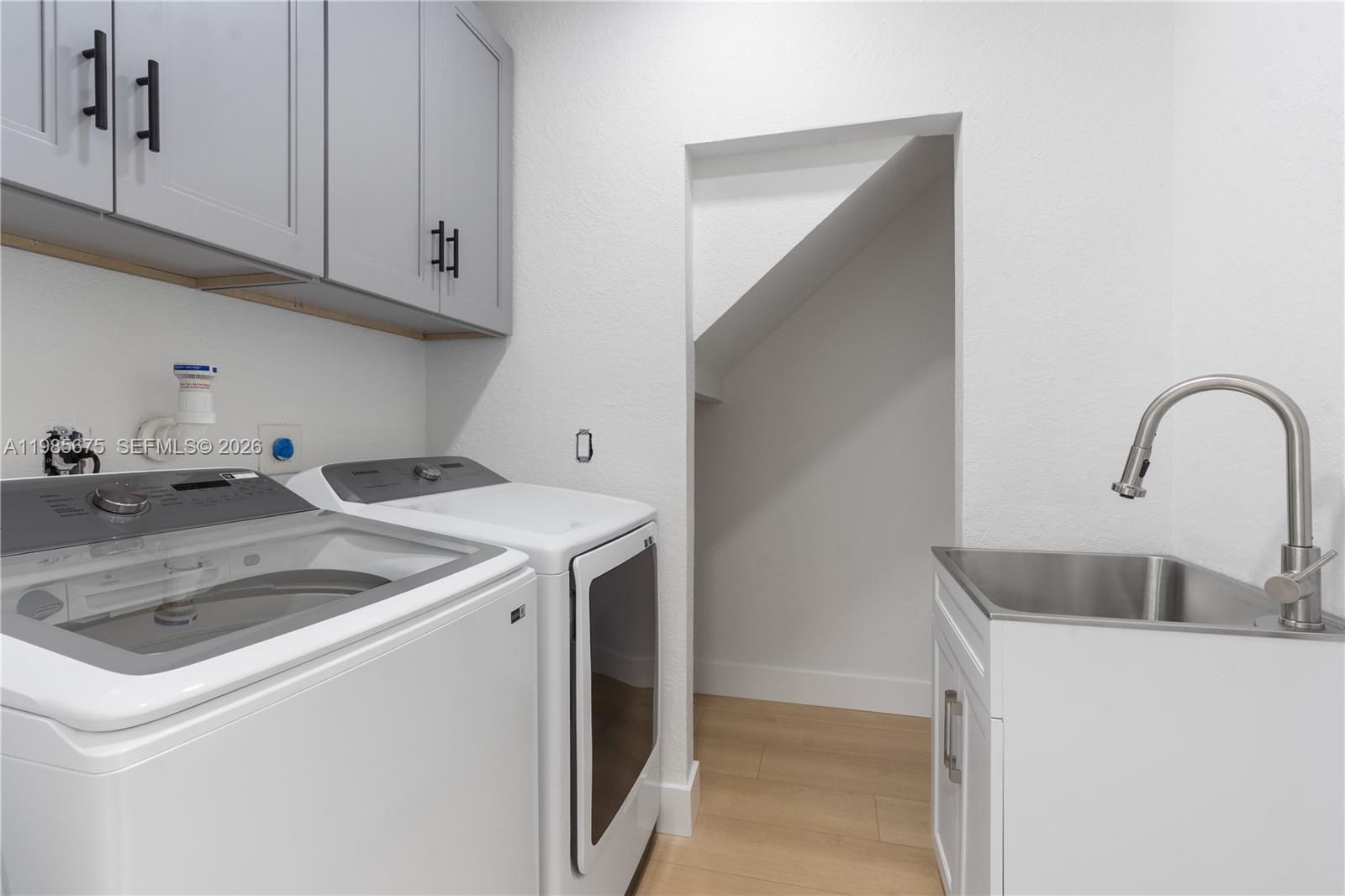 9840 Stover Way Wellington, FL 33414 - Photo 18 of 23 a utility room with sink dryer and washer