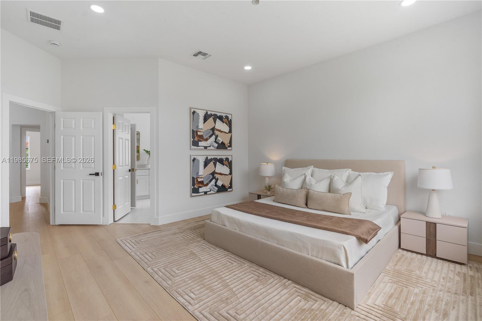 9840 Stover Way Wellington, FL 33414 - Photo 20 of 23 a spacious bedroom with a bed and a walk in closet