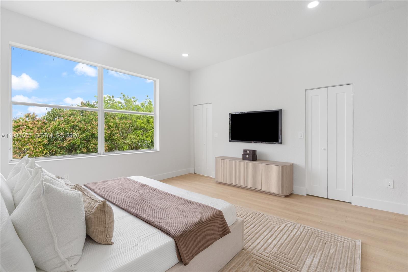 9840 Stover Way Wellington, FL 33414 - Photo 21 of 23 a bedroom with a bed and a flat screen tv