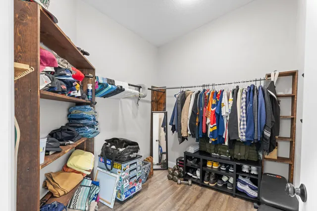 a open dining room with stainless steel appliances kitchen island granite countertop a dining table chairs and a refrigerator