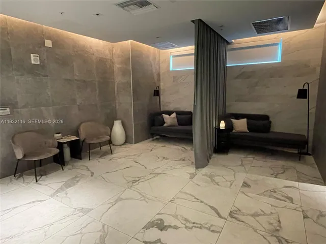 a bedroom with a bed and a lamp