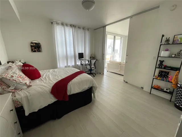 a bedroom with a bed and a tv