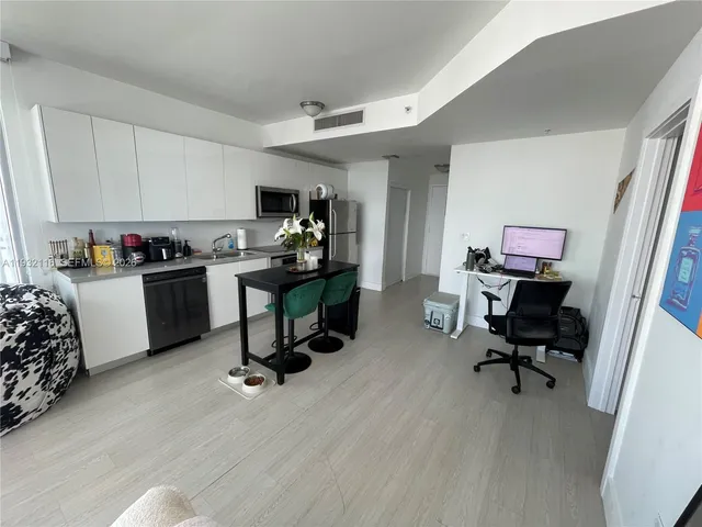 a view of a workspace with furniture and lounge chair